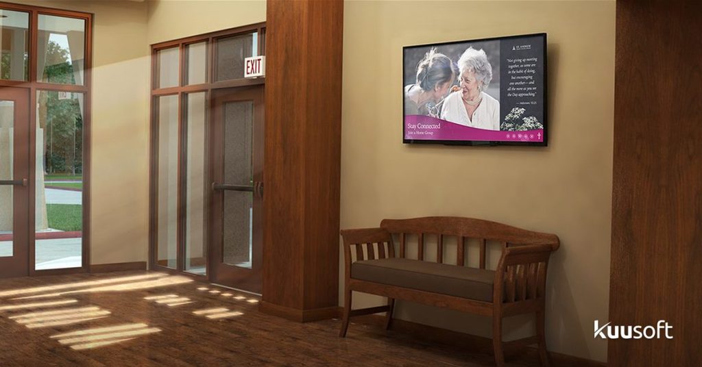 church hallway showing a wall-mounted digital signage display